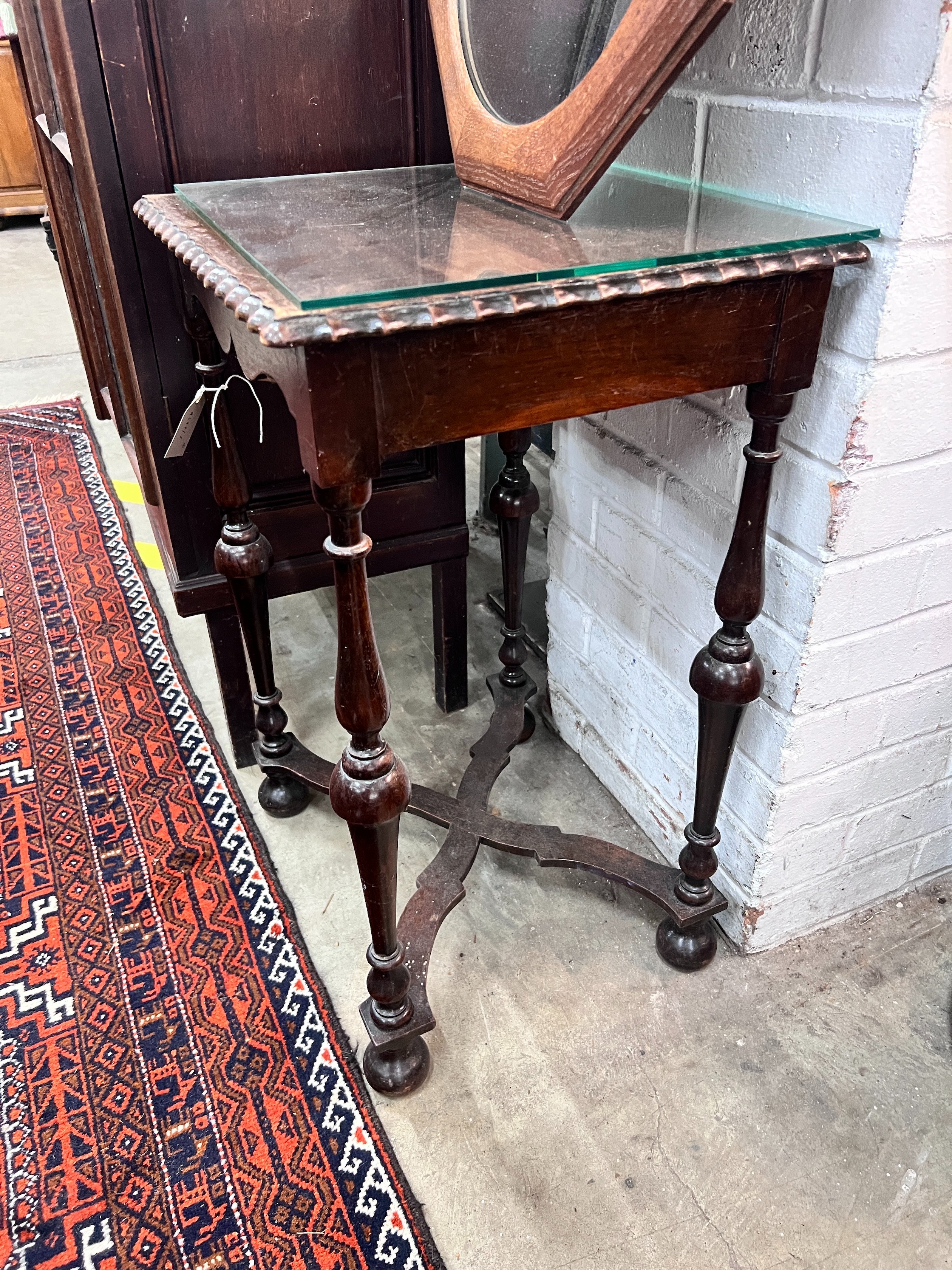 A 1920's mahogany side table, width 45cm, height 70cm, together with an octagonal oak framed wall mirror *Please note the sale commences at 9am.